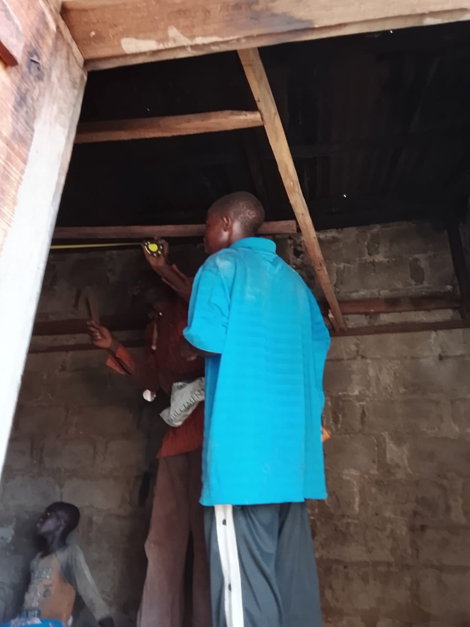 A man fixing the roof at the care facility.